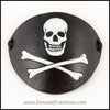 A handmade leather Jolly Roger eye patch, with hand carved and painted skull and bones, for a masquerade costume or pirate cosplay. By Erin Metcalf of Eirewolf Creations.