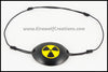 A handmade leather eye patch with a carved and painted radiation hazard symbol in black and yellow, for a masquerade costume or pirate cosplay. By Erin Metcalf of Eirewolf Creations.