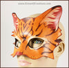 A handmade leather tabby cat mask for a masquerade costume, light brown with handpainted dark brown stripes and a dark pink nose and inner ears. By Erin Metcalf of Eirewolf Creations.