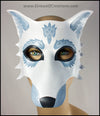 A handmade leather masquerade costume mask of a winter white wolf with silver fur details. By Erin Metcalf of Eirewolf Creations.