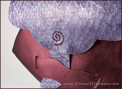 Handmade leather belt pouches in a medieval style with a scaled dragon skin texture, in purple or silver colors. Detail view. By Erin Metcalf of Eirewolf Creations.