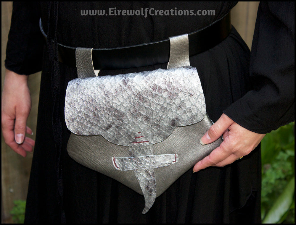 Handmade leather belt pouches in a medieval style with a scaled dragon skin texture, in purple or silver colors. By Erin Metcalf of Eirewolf Creations.