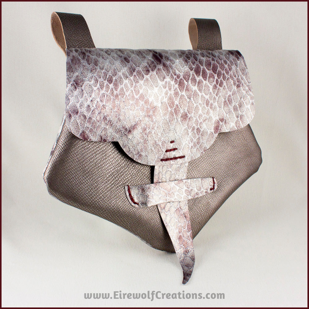 Handmade leather belt pouches in a medieval style with a scaled dragon skin texture, in purple or silver colors. By Erin Metcalf of Eirewolf Creations.