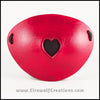 A handmade leather dyed red eye patch with a heart cut out, backed with transparent black fabric to allow some visibility, for a masquerade costume or pirate cosplay. By Erin Metcalf of Eirewolf Creations.
