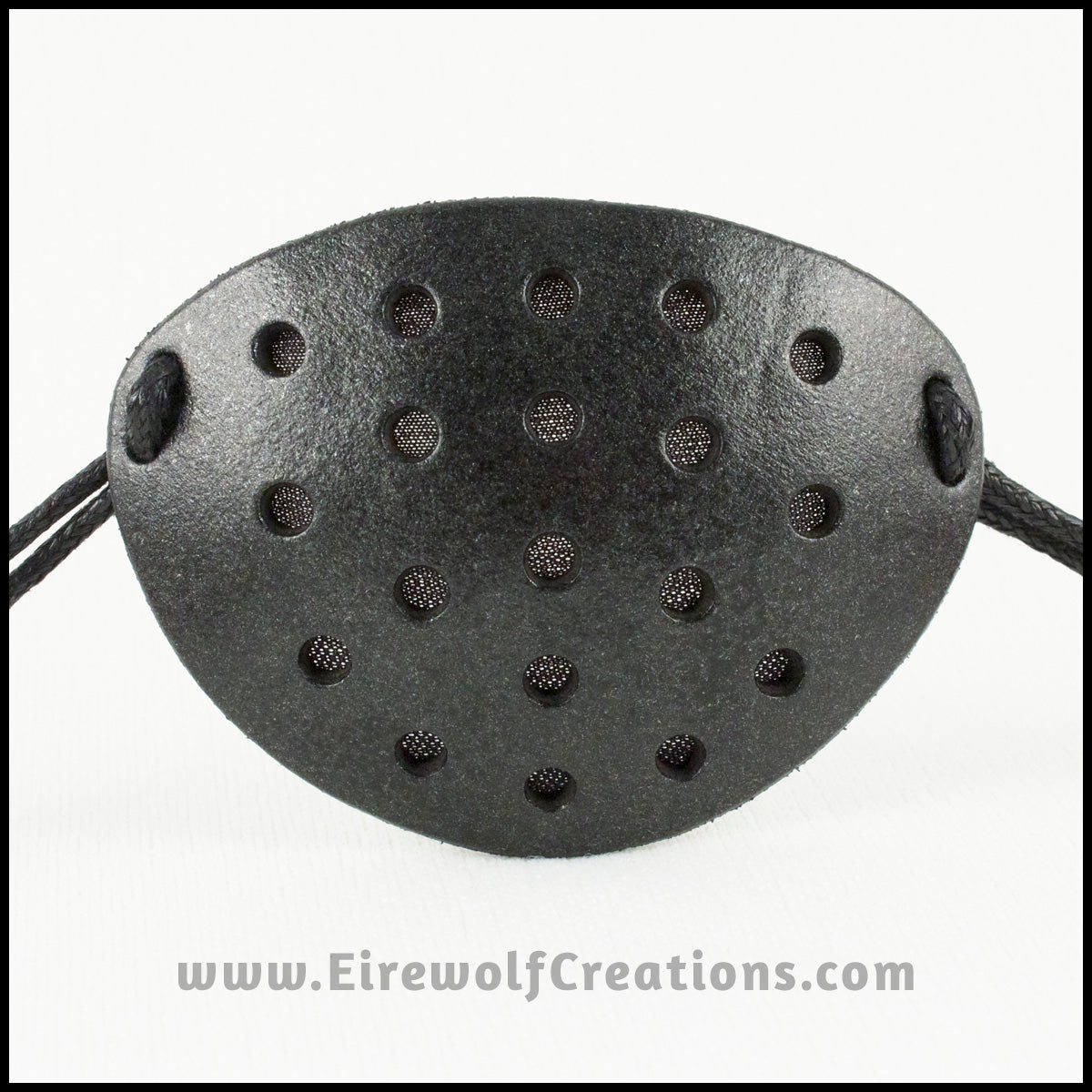 A handmade leather industrial style costume eye patch with 19 holes punched in it to allow some visibility, painted subtly sparkly black and backed with transparent black fabric. By Erin Metcalf of Eirewolf Creations.