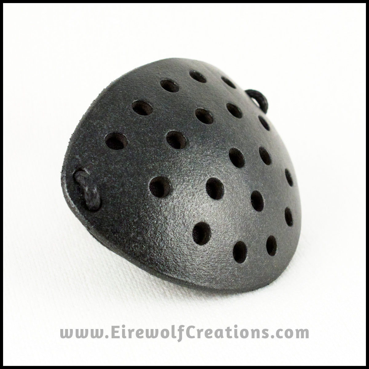 A handmade leather industrial style costume eye patch with 19 holes punched in it to allow some visibility, painted subtly sparkly black and backed with transparent black fabric. By Erin Metcalf of Eirewolf Creations.