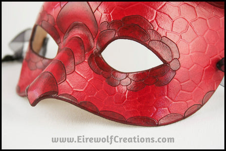 Closeup of a scaled red dragon masquerade costume half mask with curving horns. By Erin Metcalf of Eirewolf Creations.