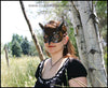 A Great Horned Owl handmade leather masquerade costume mask, dyed dark brown and carved and painted with feather details. By Erin Metcalf of Eirewolf Creations.