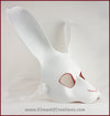 A handmade leather White Rabbit mask for a masquerade or Alice in Wonderland costume, painted white with red details around the eyes and nose. By Erin Metcalf of Eirewolf Creations.
