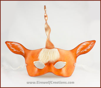 A handmade leather palomino unicorn mask for a masquerade costume, with a twisting horn and cream-colored forelock made of real deer hair. By Erin Metcalf of Eirewolf Creations.