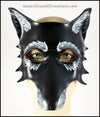 A grizzled Black Wolf mask for a masquerade costume, handmade from leather with carved and painted fur details. By Erin Metcalf of Eirewolf Creations.
