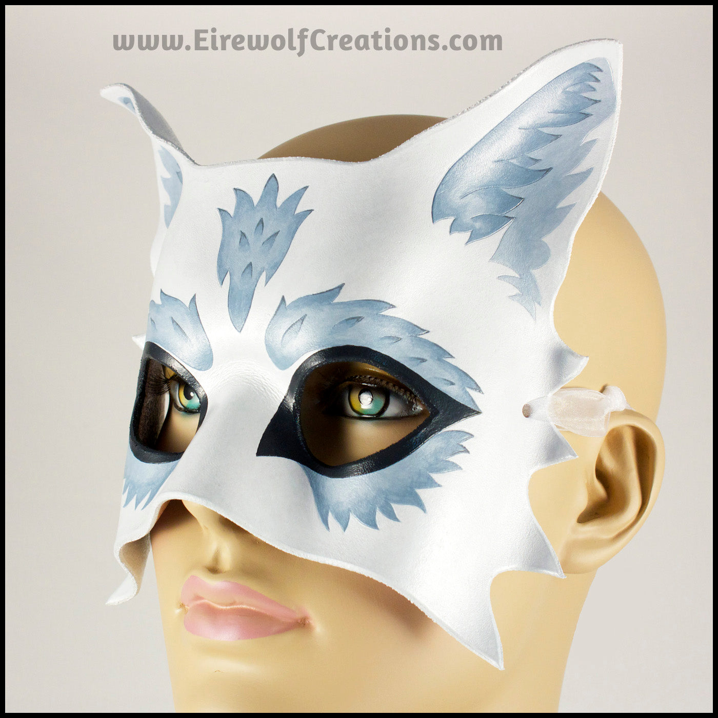 Silver Wolf half mask for a masquerade costume, handmade from leather and painted white with silvery fur details. By Erin Metcalf of Eirewolf Creations.